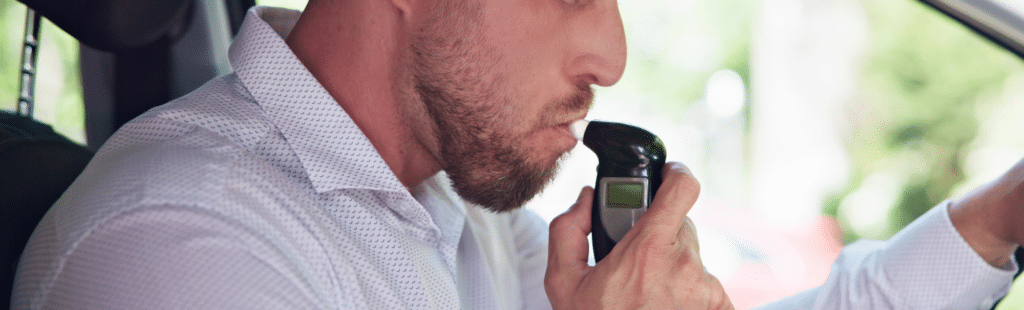 image of someone taking a breathalyzer test