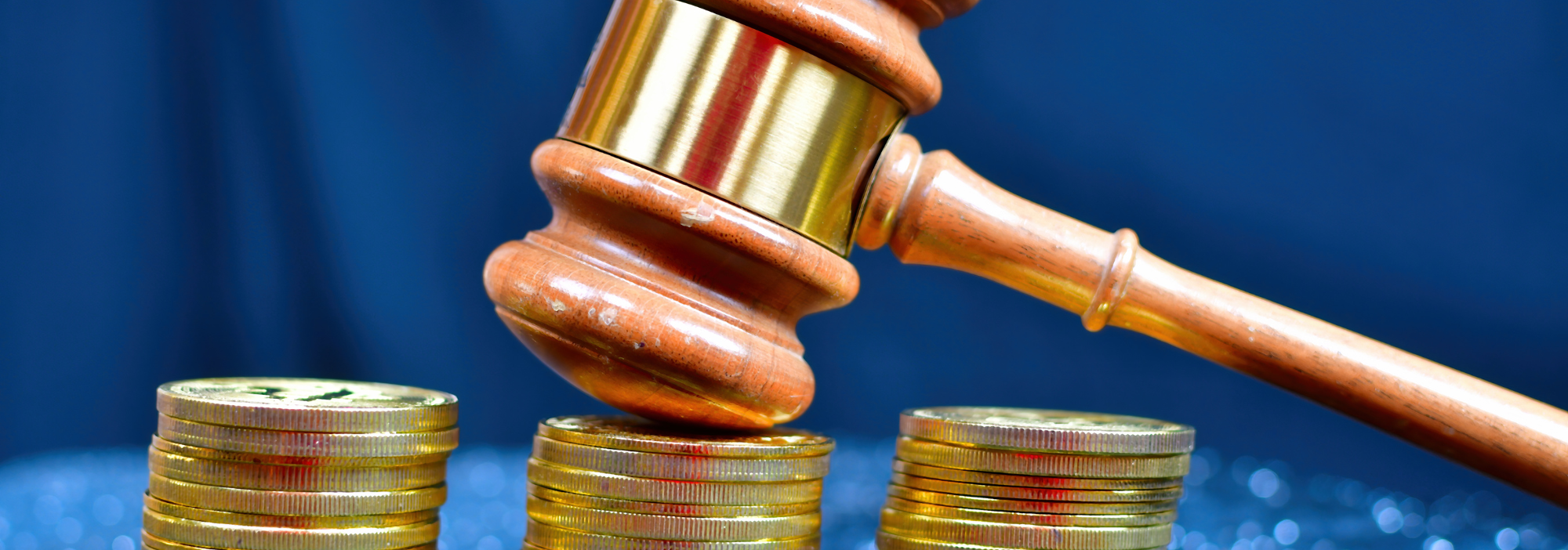 gavel resting on stack of coins